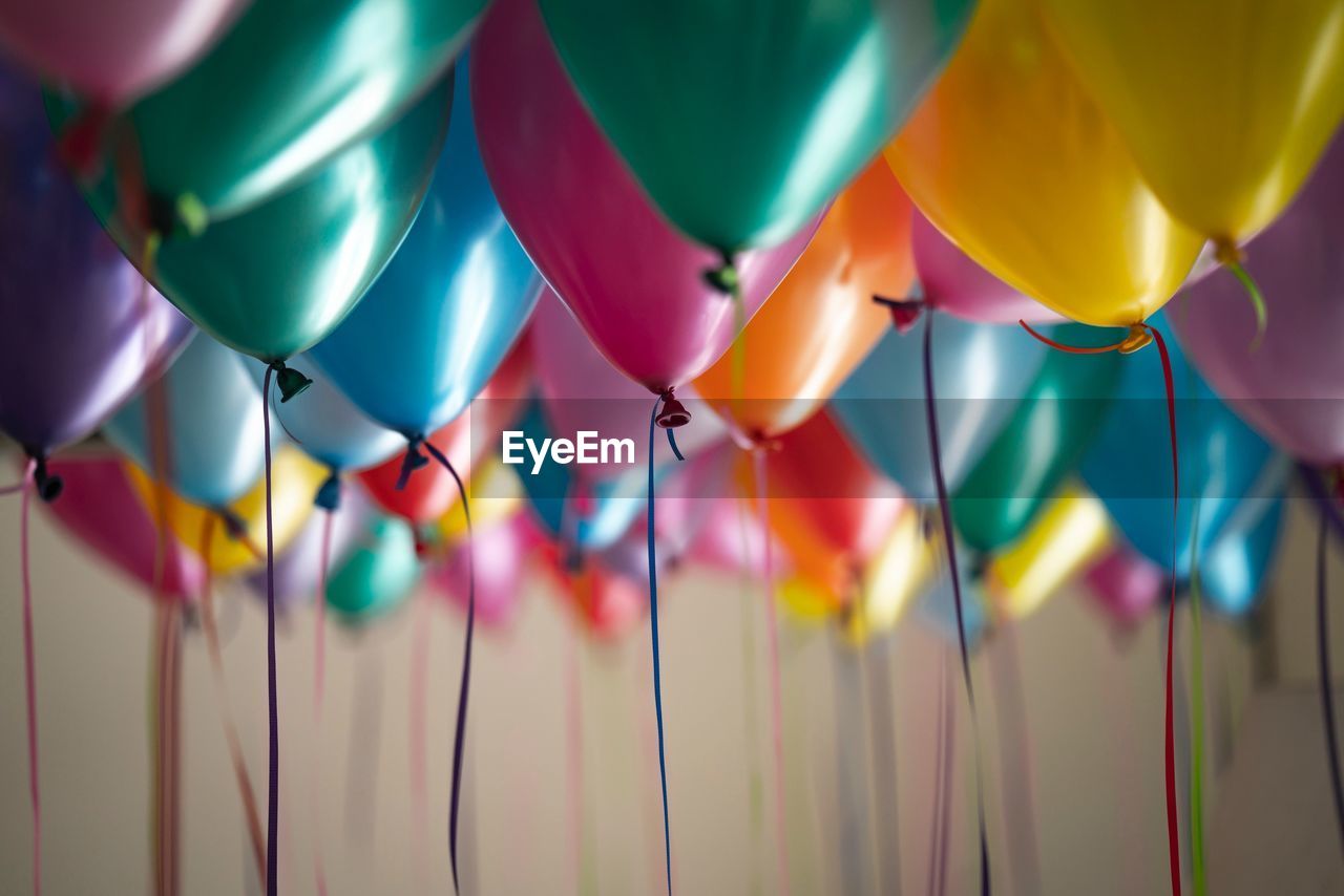 Close-up of colorful balloons hanging at home