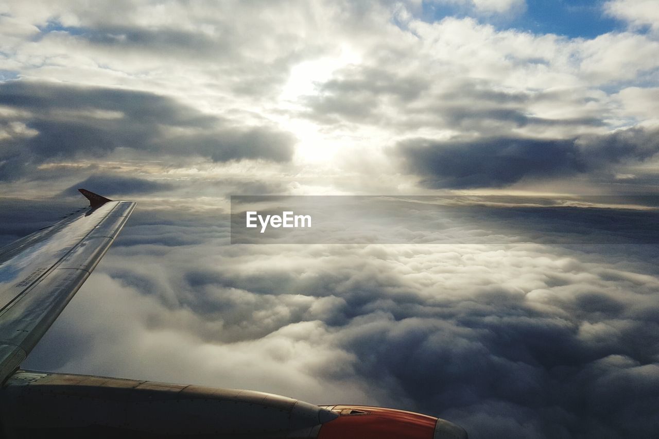 Cropped image of airplane over clouds