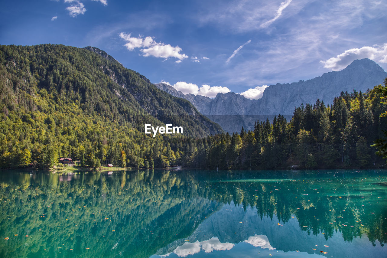 Scenic view of lake and mountains against sky