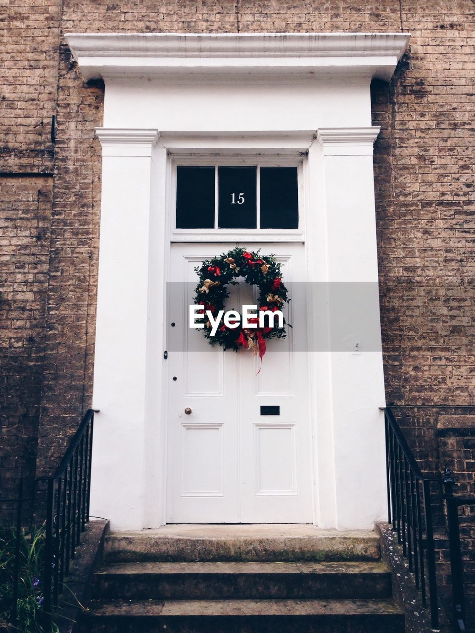 Flower wreath on white door