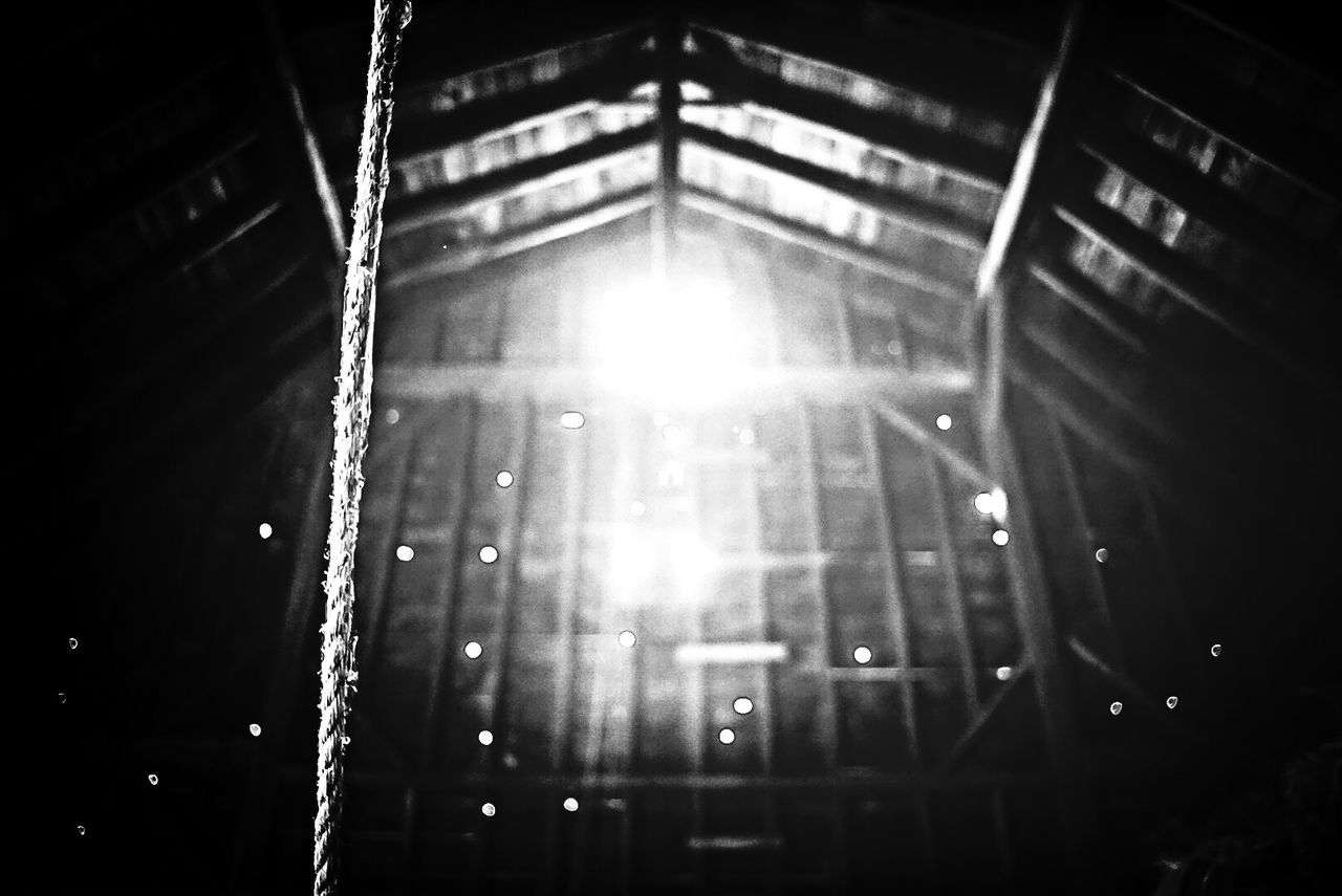 Close-up of rope against light in barn