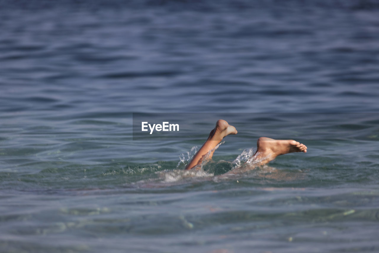 BOY SWIMMING IN SEA