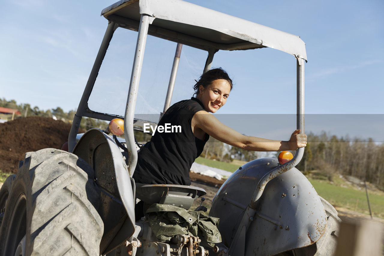 Woman driving tractor