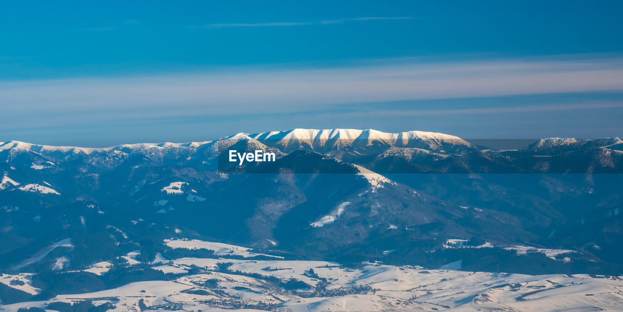 Scenic view of snowcapped mountains against sky