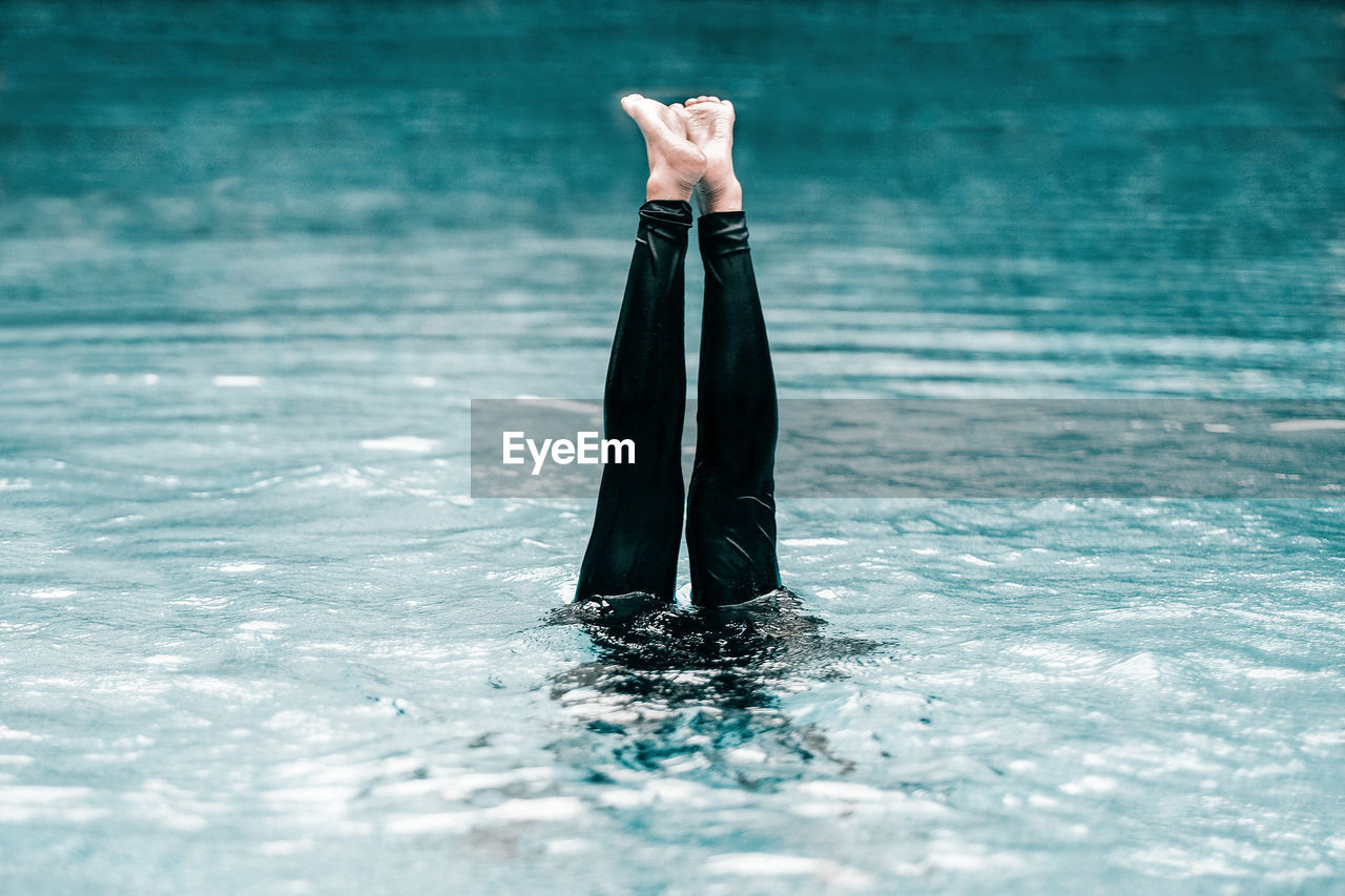 Cropped image of woman leg in swimming pool