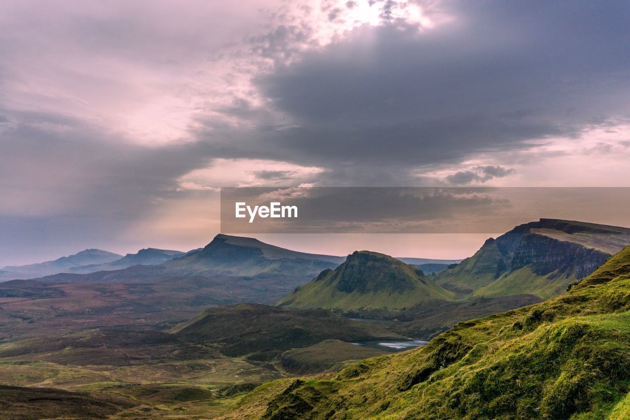 Scenic view of mountains against cloudy sky