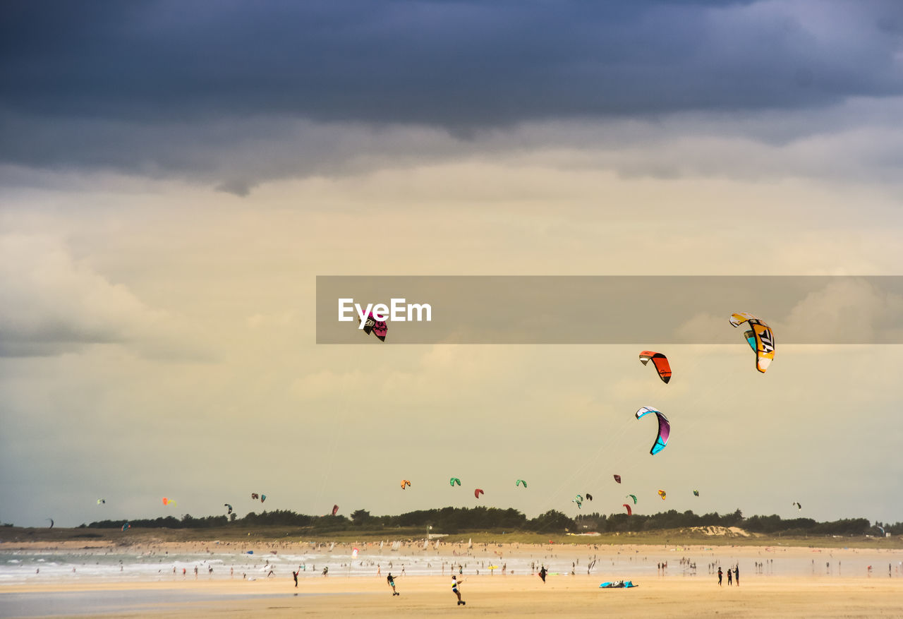 People with kiteboards at beach