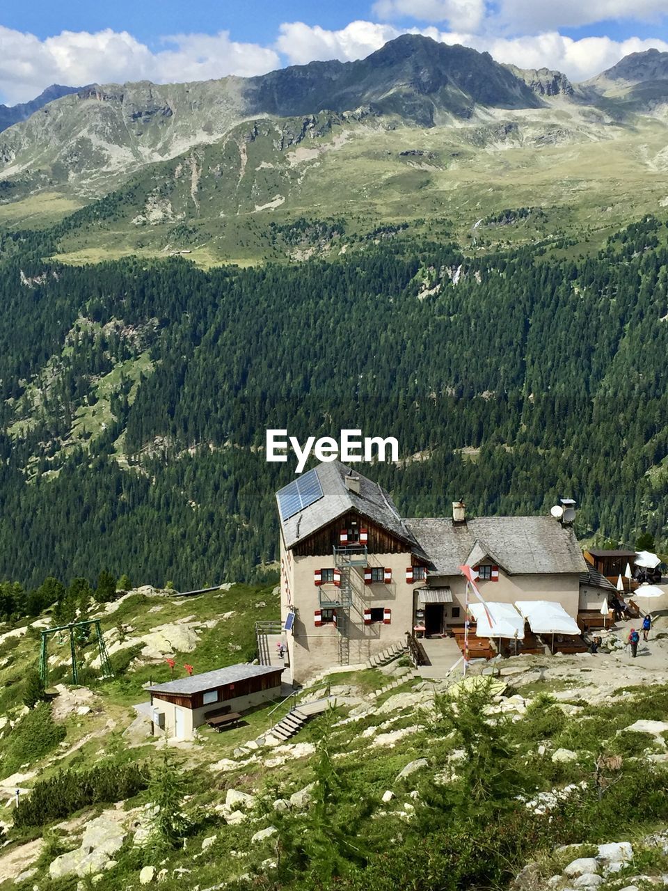 Scenic view of landscape and houses against mountains