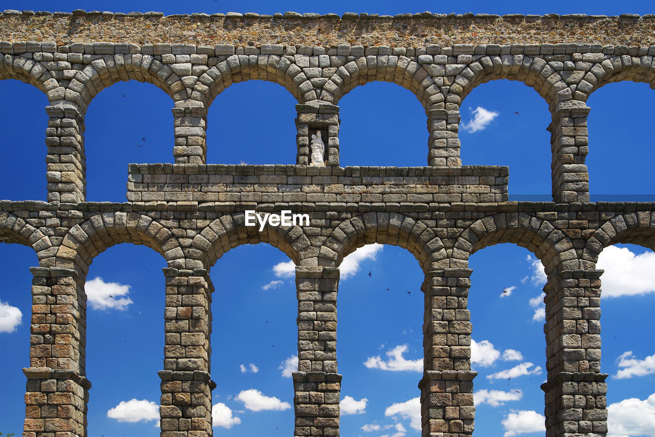 Low angle view of aqueduct of segovia against sky