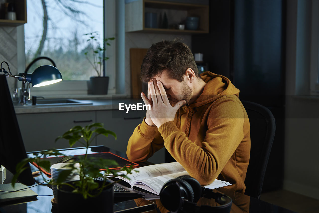 Man working late remotely at home