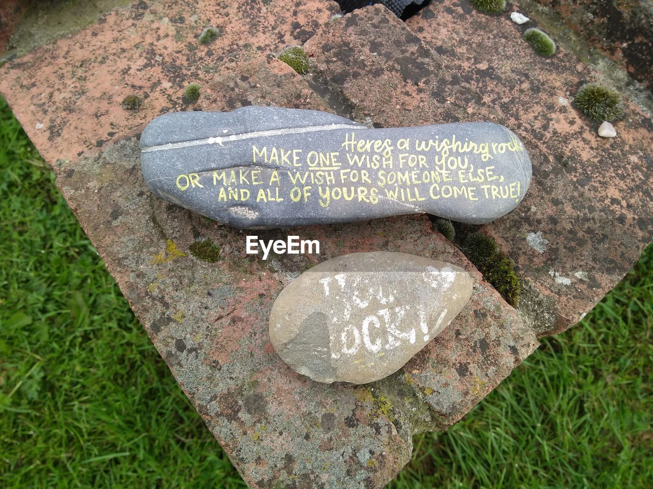 High angle view of text on rock