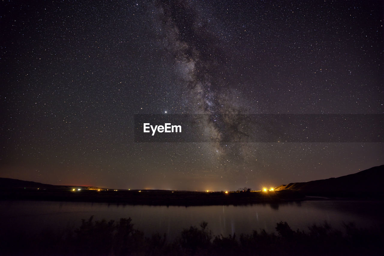 Scenic view of lake against star field at night