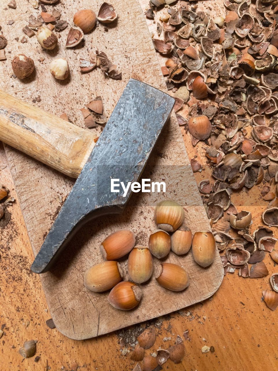 High angle view of nuts next to hammer