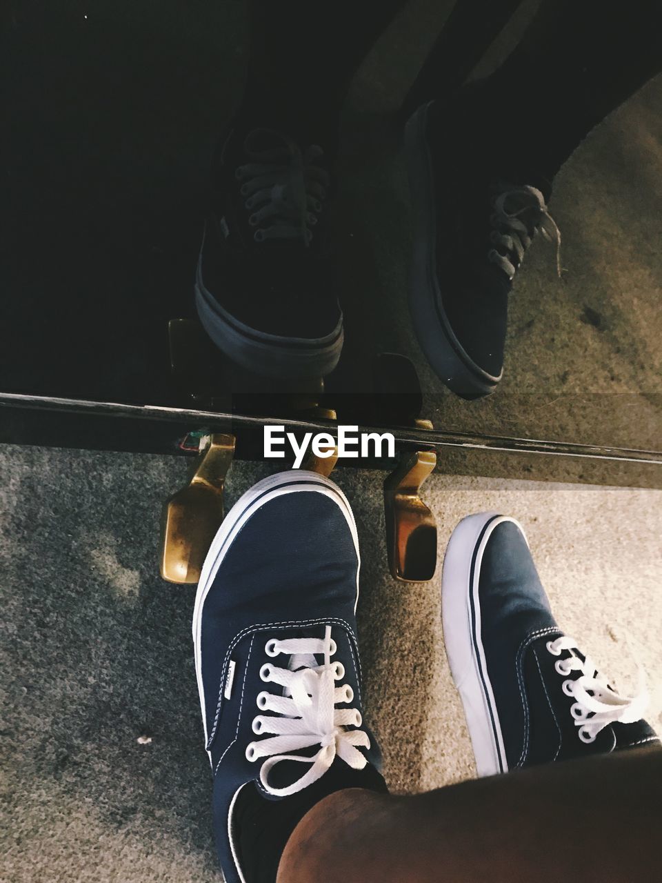 HIGH ANGLE VIEW OF MAN WEARING SHOES ON FLOOR