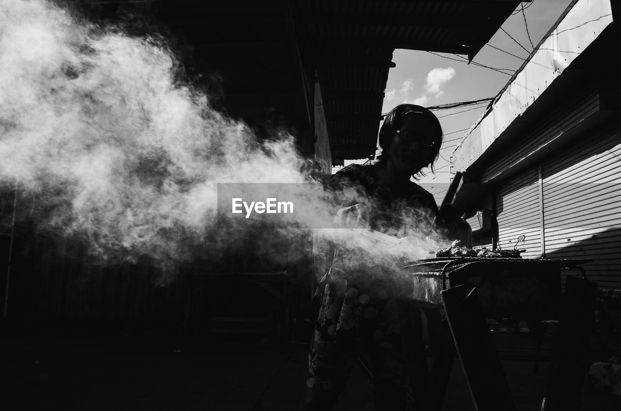 SIDE VIEW OF MAN WORKING ON VEHICLE