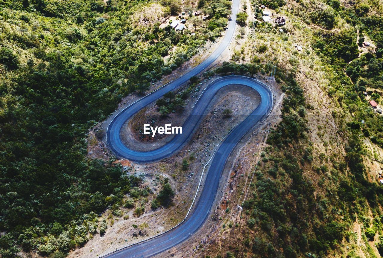 High angle view of winding road amidst trees