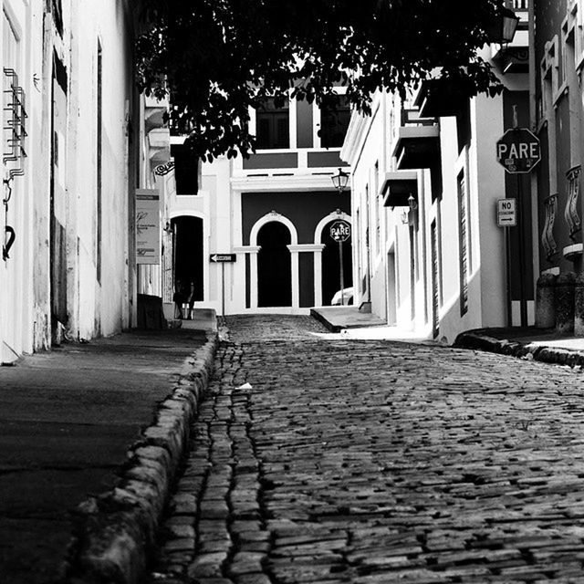 NARROW ALLEY WITH BUILDINGS IN BACKGROUND