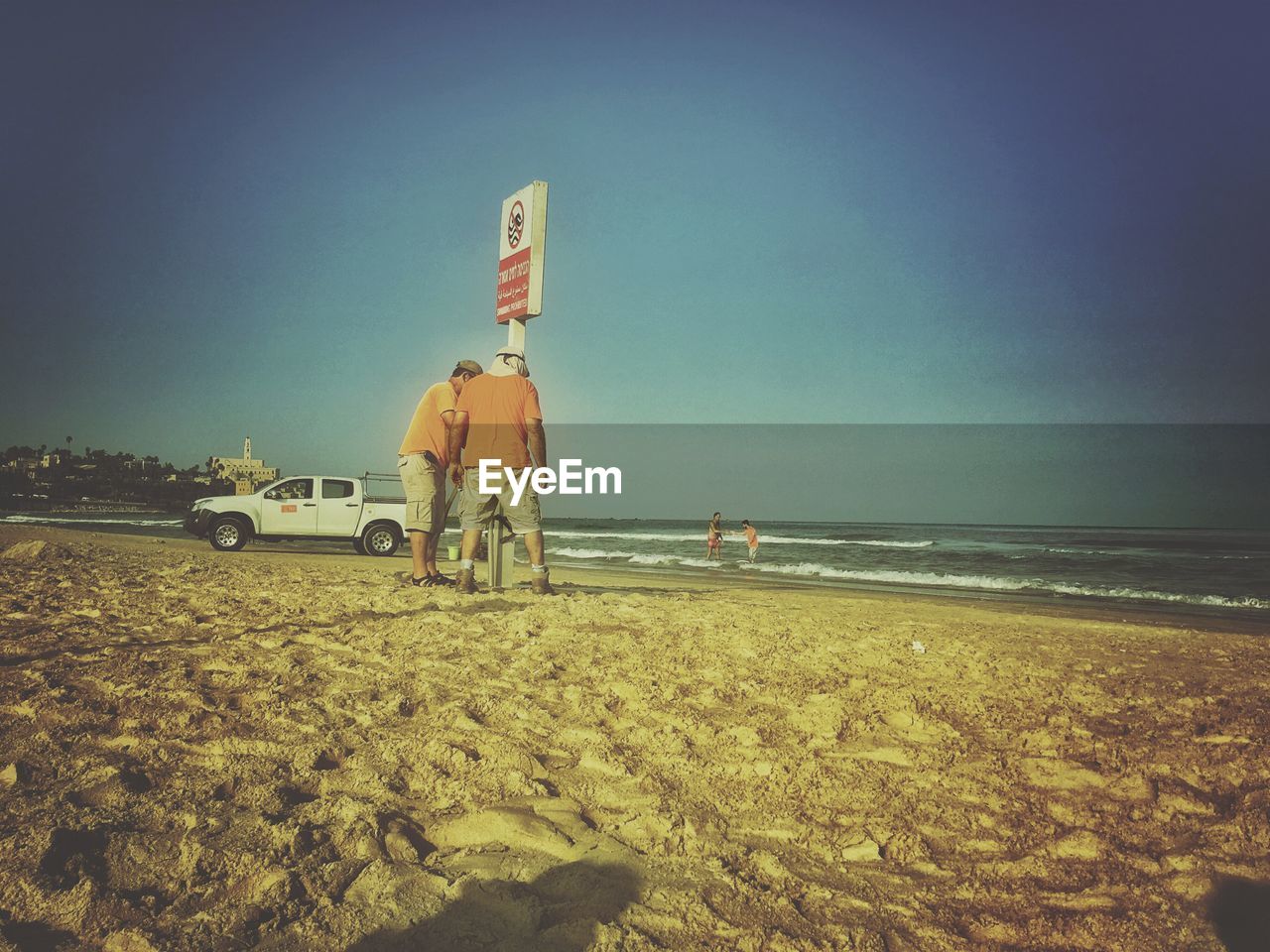 REAR VIEW OF A MAN ON BEACH