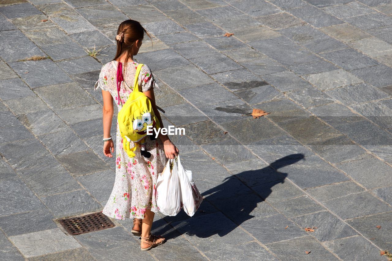 FULL LENGTH REAR VIEW OF WOMAN ON FOOTPATH