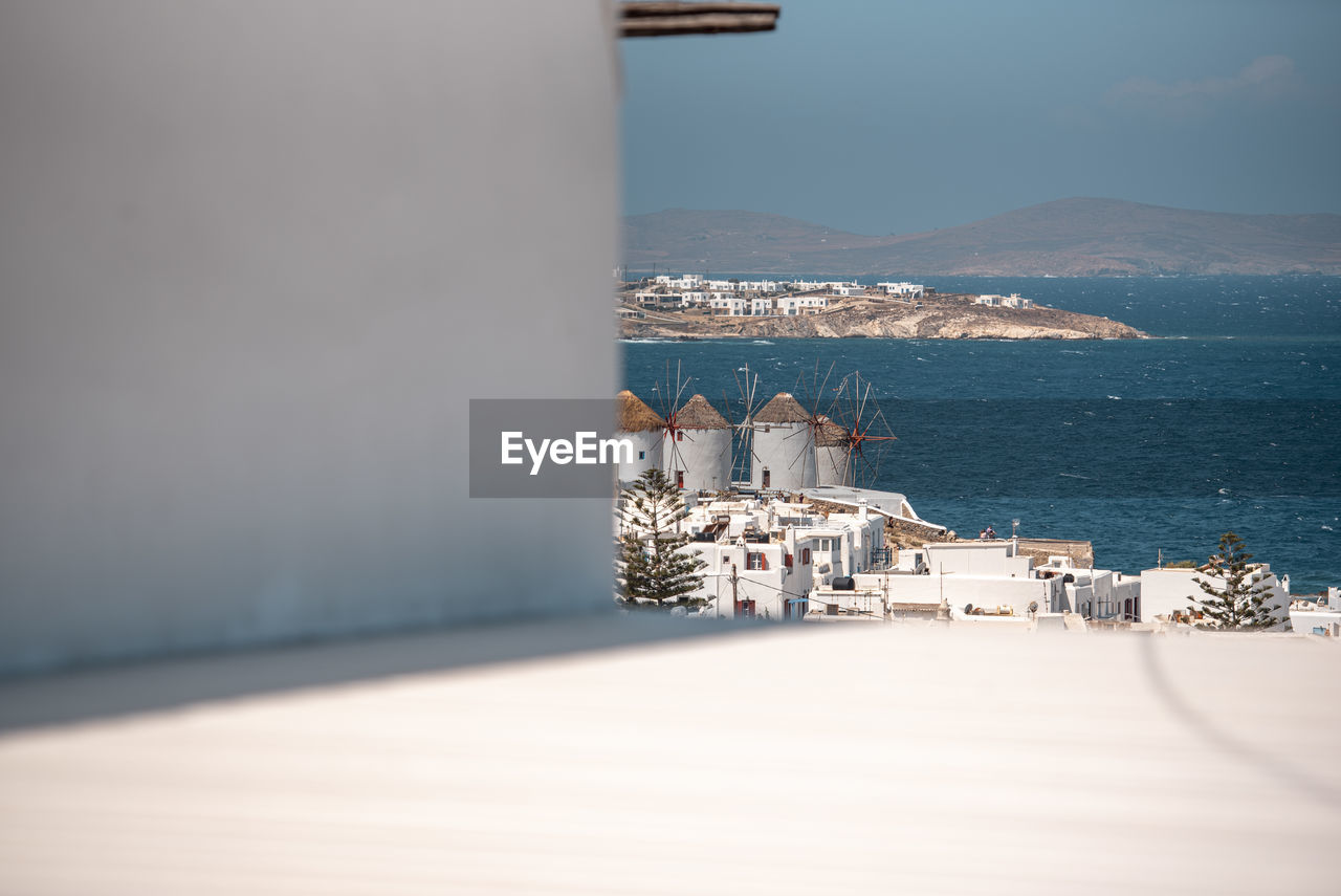 water, architecture, sea, building exterior, built structure, nature, sky, building, travel destinations, blue, ocean, no people, travel, land, day, scenics - nature, city, white, beach, outdoors, sunlight, beauty in nature, tourism, tranquility, copy space, coast, mountain, cloud