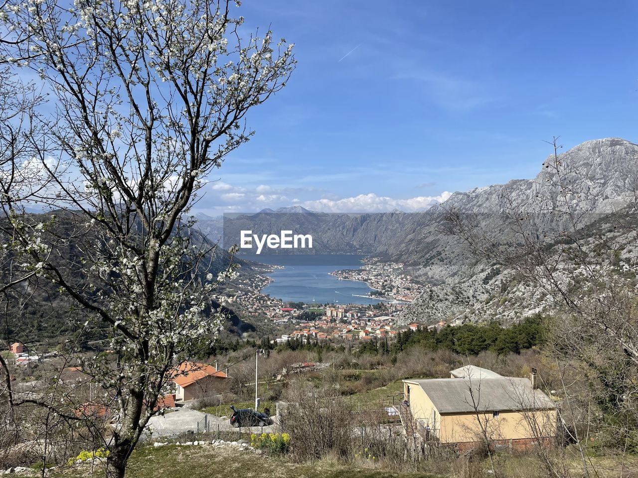 mountain, tree, plant, nature, scenics - nature, mountain range, beauty in nature, sky, landscape, flower, architecture, environment, no people, building, built structure, day, land, building exterior, water, travel destinations, outdoors, house, tranquility, tranquil scene, travel, snow, springtime, wilderness, valley, non-urban scene, branch, growth, winter, tourism, blue