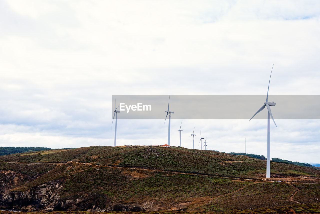 Wind turbines on field against sky. galicia, spain