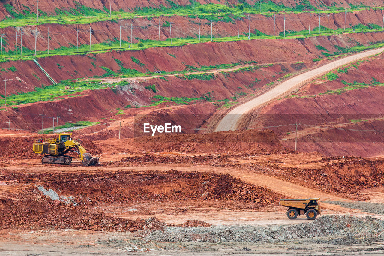 Construction vehicles against mountains