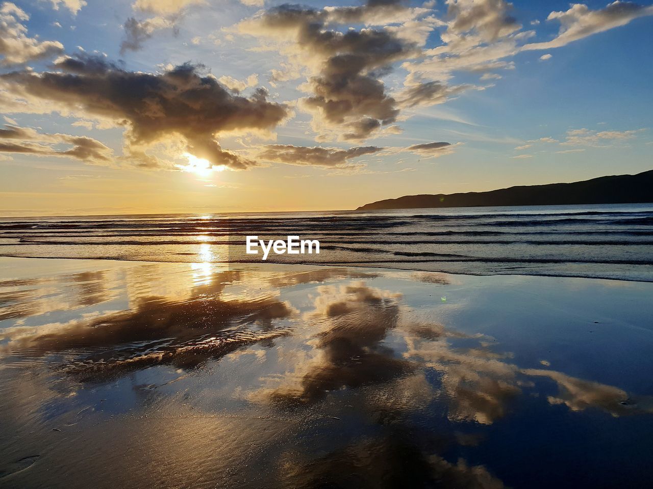 Scenic view of sea against sky at sunset