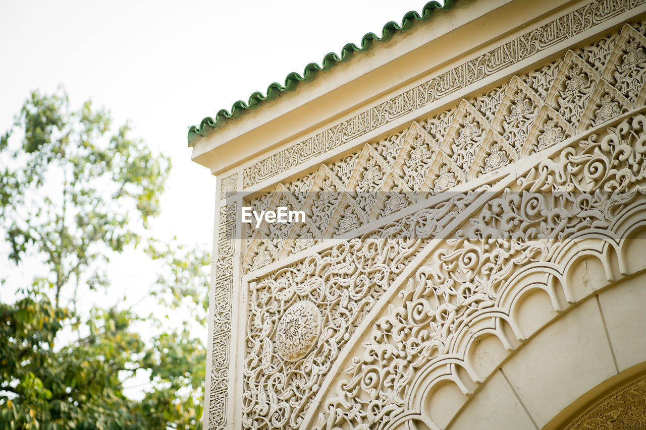 Low angle view of morrocan ornate building against sky