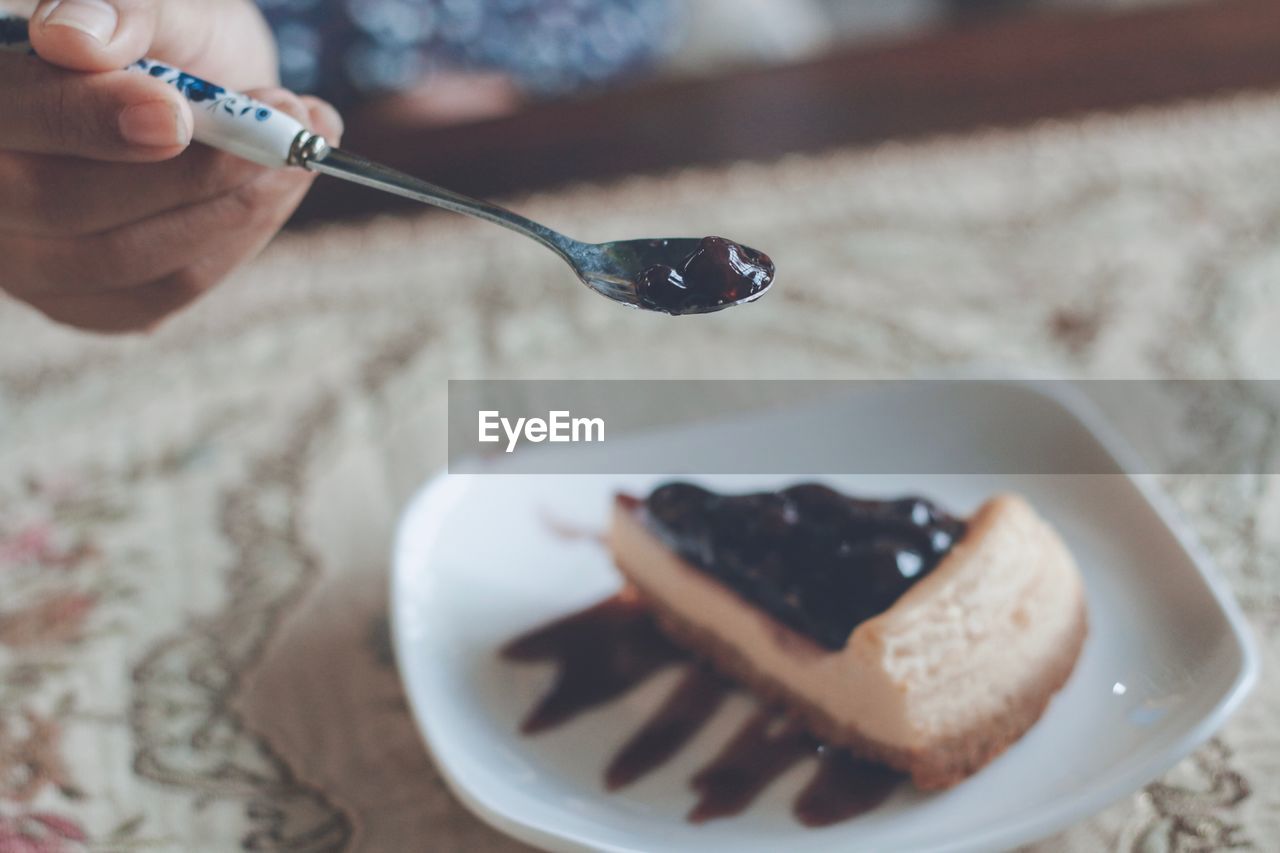 Close-up of person eating pie 