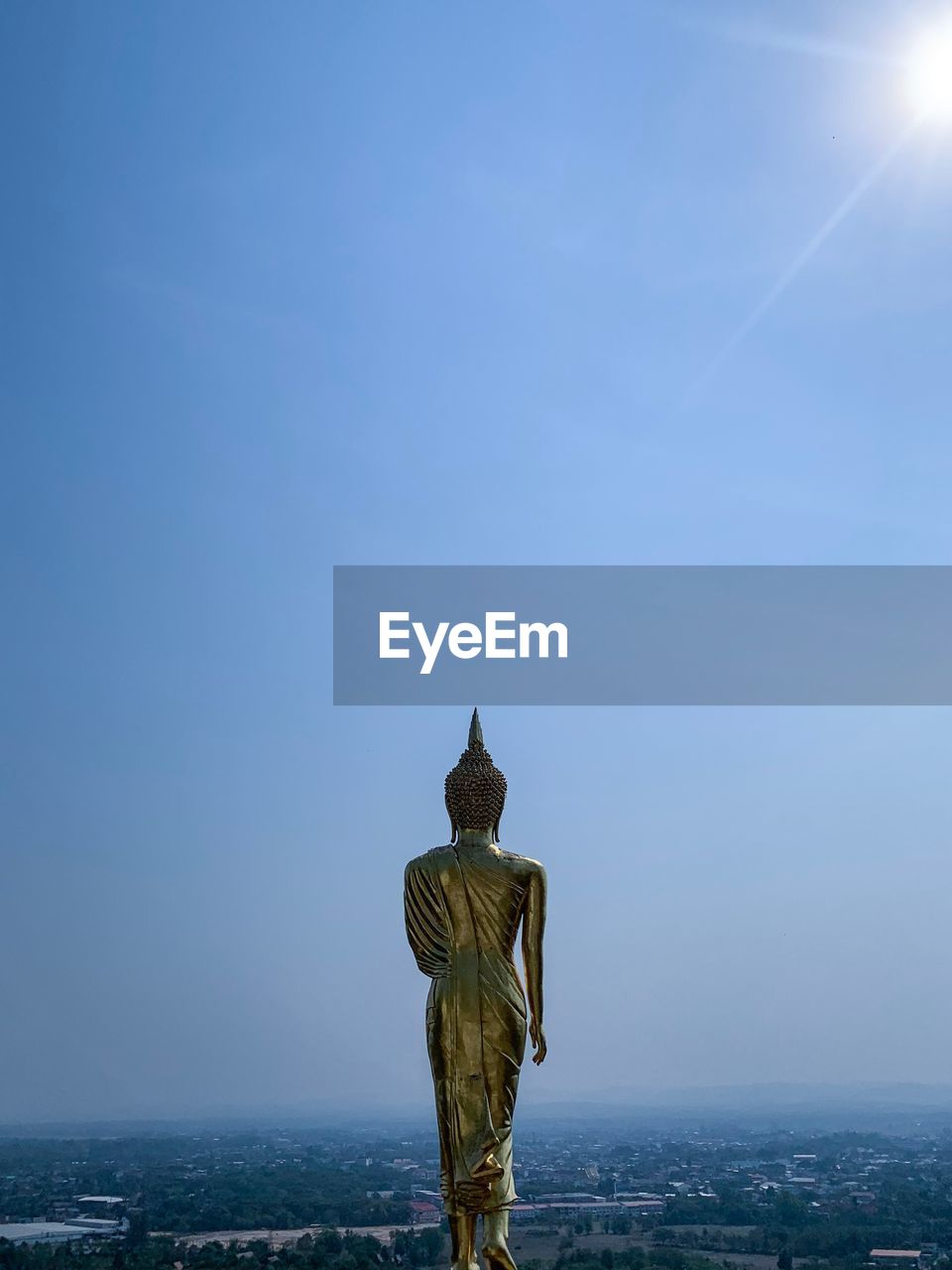 STATUE AGAINST BLUE SKY