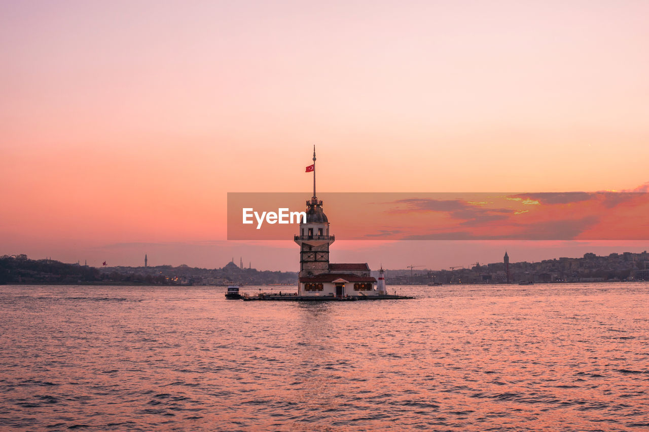 SCENIC VIEW OF SEA AGAINST ORANGE SKY