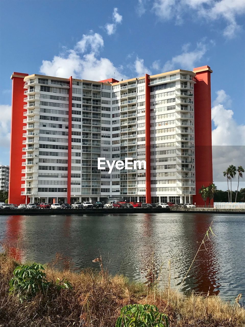 Building by river against sky