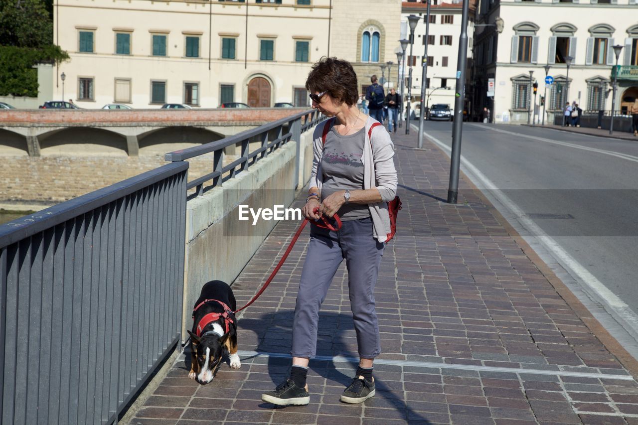 PEOPLE WALKING ON STREET IN CITY