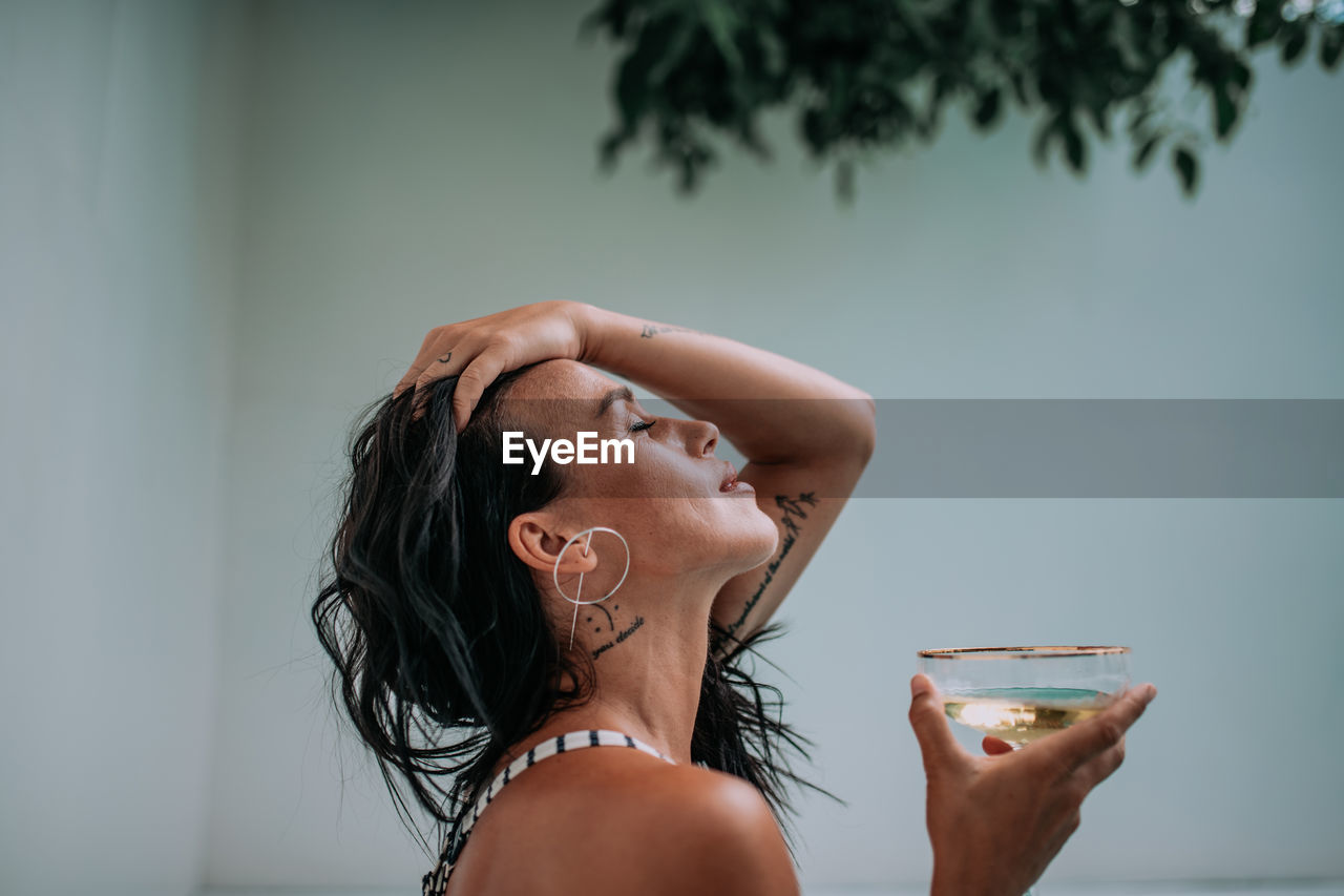 Close-up portrait of a woman drinking glass