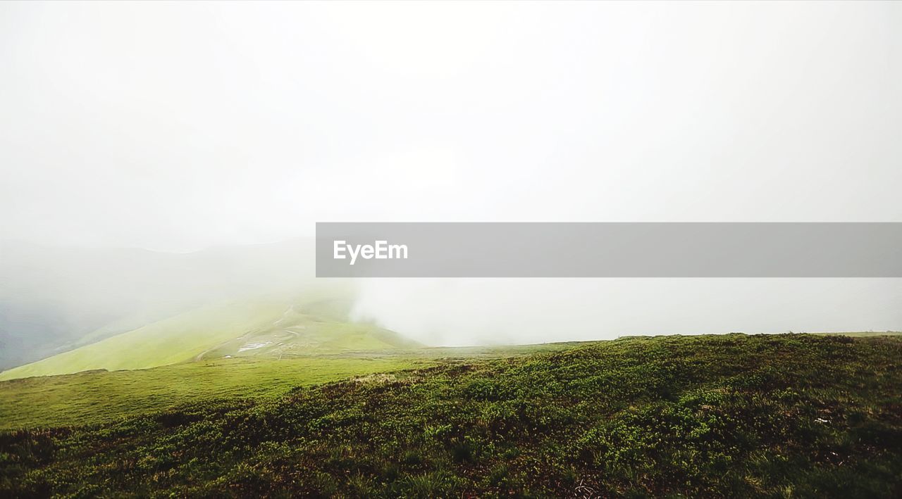 SCENIC VIEW OF FOGGY LANDSCAPE AGAINST SKY