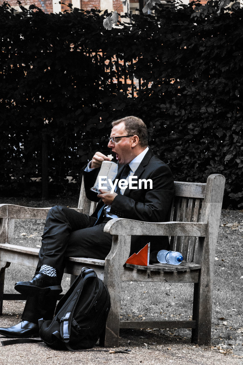 MAN SITTING ON BENCH