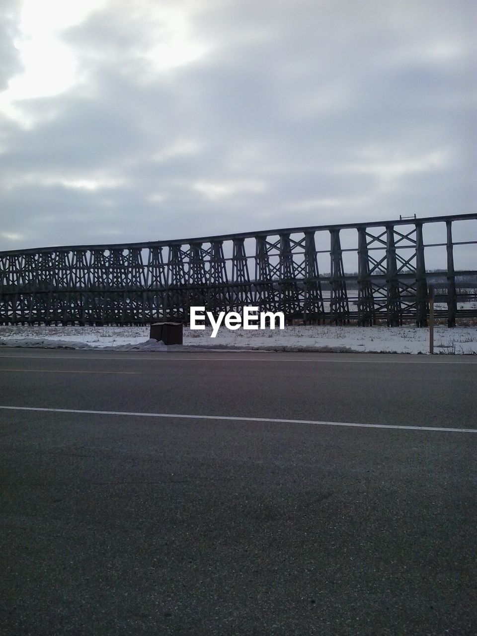 VIEW OF BRIDGE OVER RIVER AGAINST CLOUDY SKY