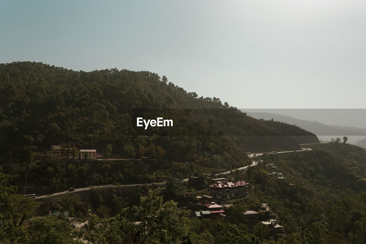 High angle view of trees and buildings against clear sky