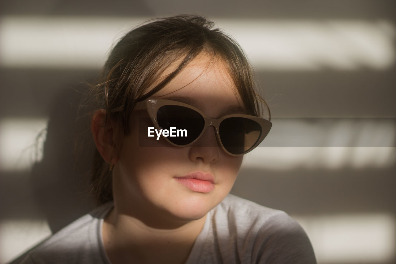 Portrait of young woman wearing sunglasses