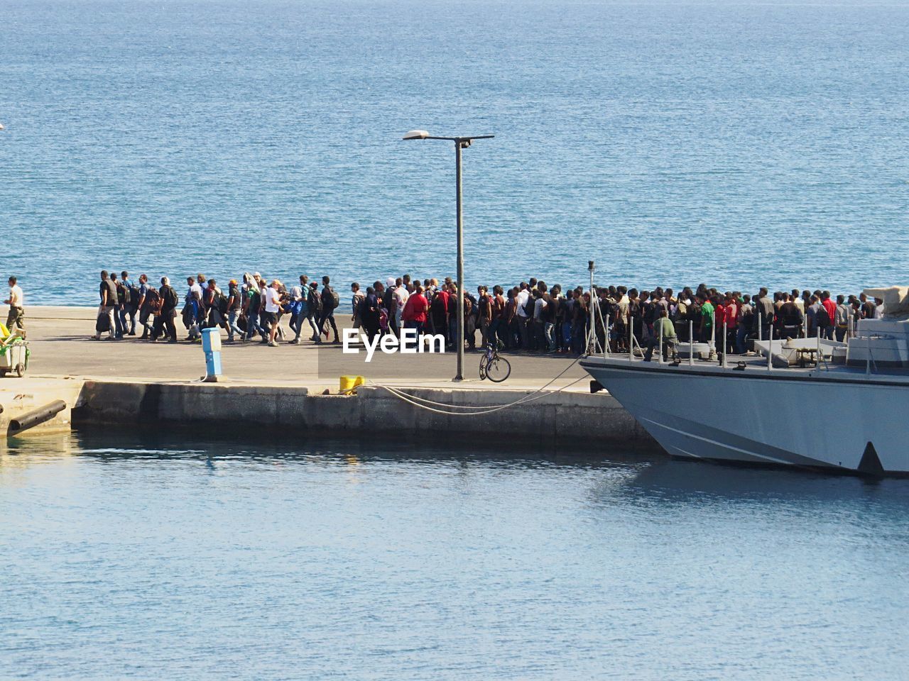 People on pier amidst sea at kos