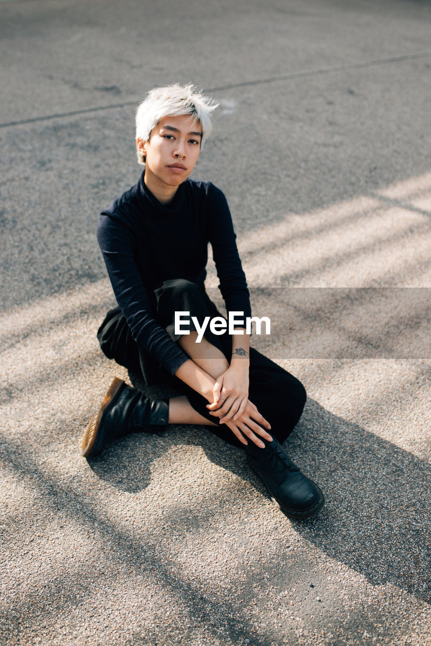 Portrait of woman sitting on street