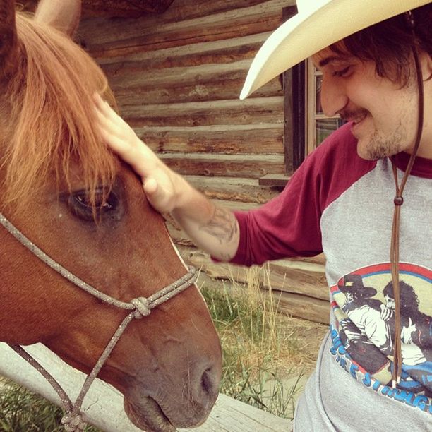 Close-up side view of a man with horse