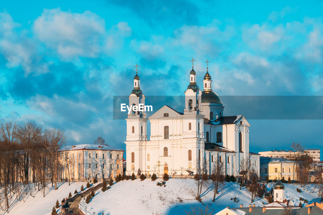 CHURCH IN CITY AGAINST SKY