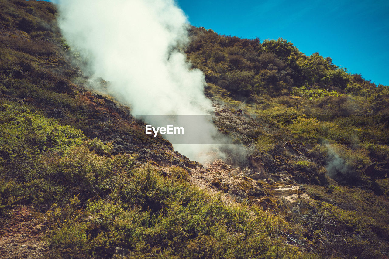 SCENIC VIEW OF SMOKE EMITTING FROM VOLCANIC MOUNTAIN