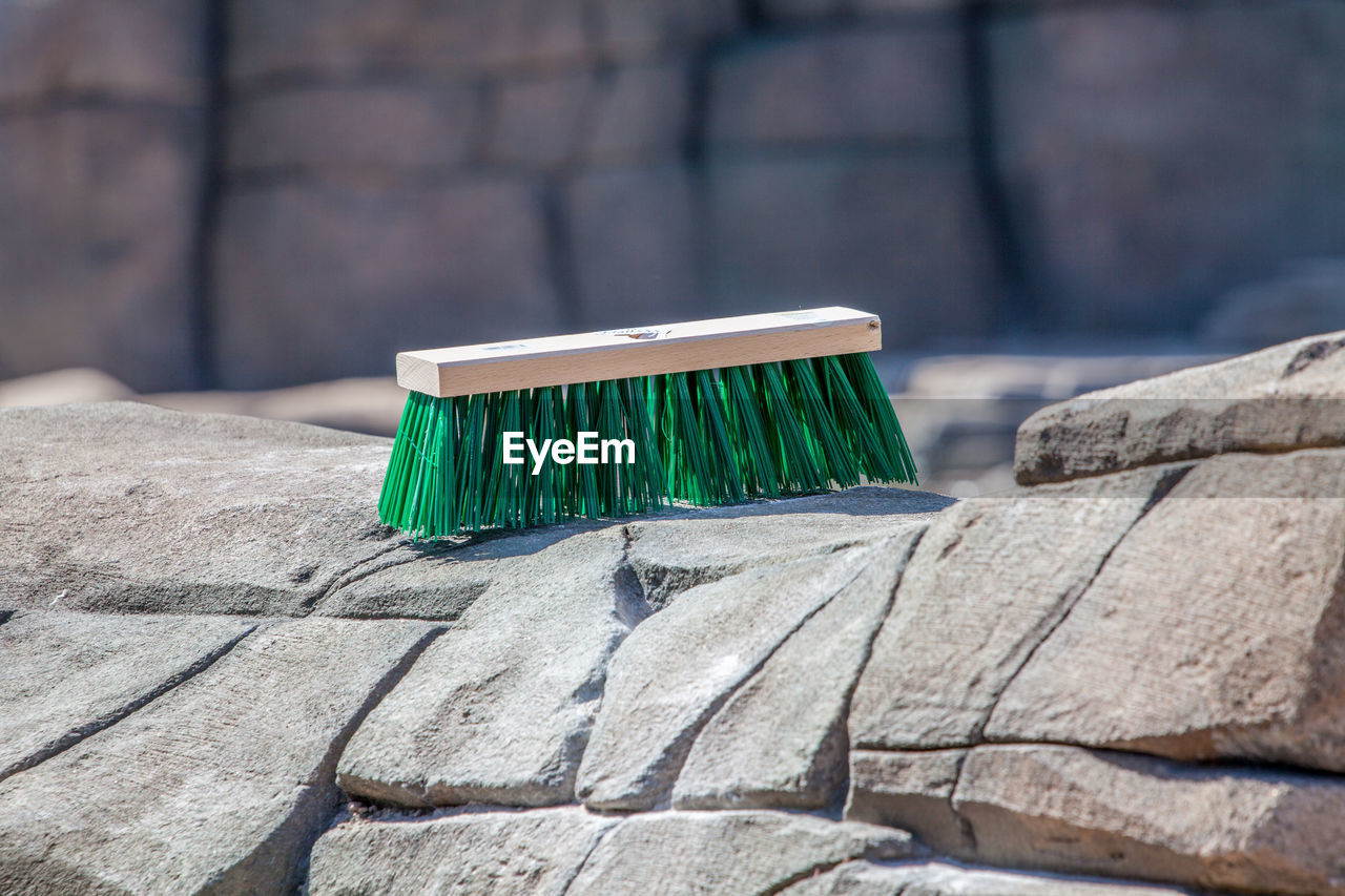 CLOSE-UP OF DECK CHAIR ON COBBLESTONE