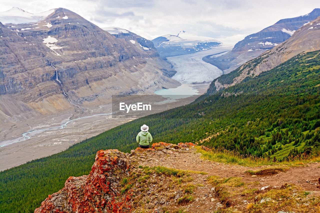 Hiker enjoying the view of the saskatchewan glacier valley in canada