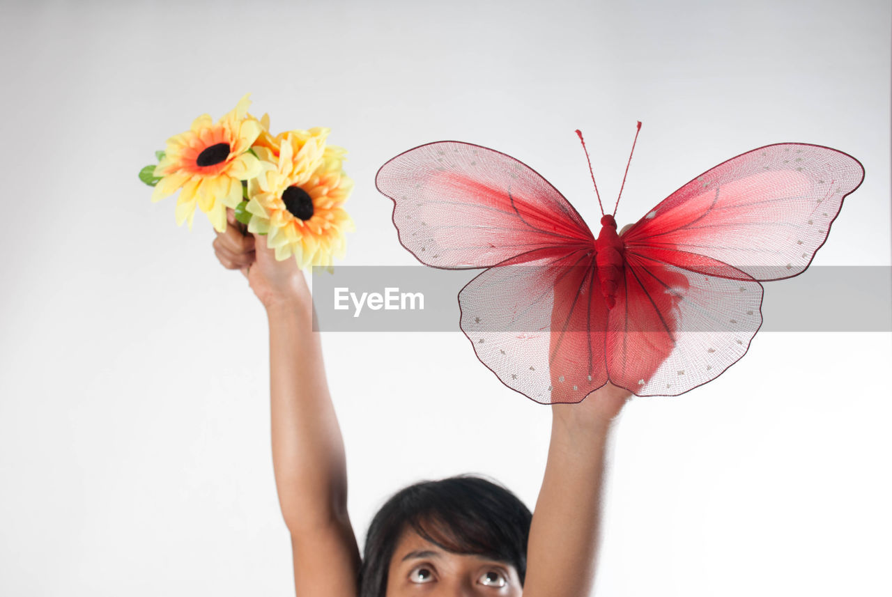 CLOSE-UP OF WOMAN HOLDING MULTI COLORED FLOWERS