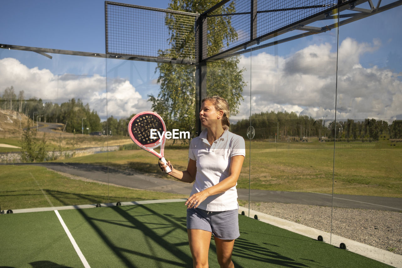 Woman holding padel racket