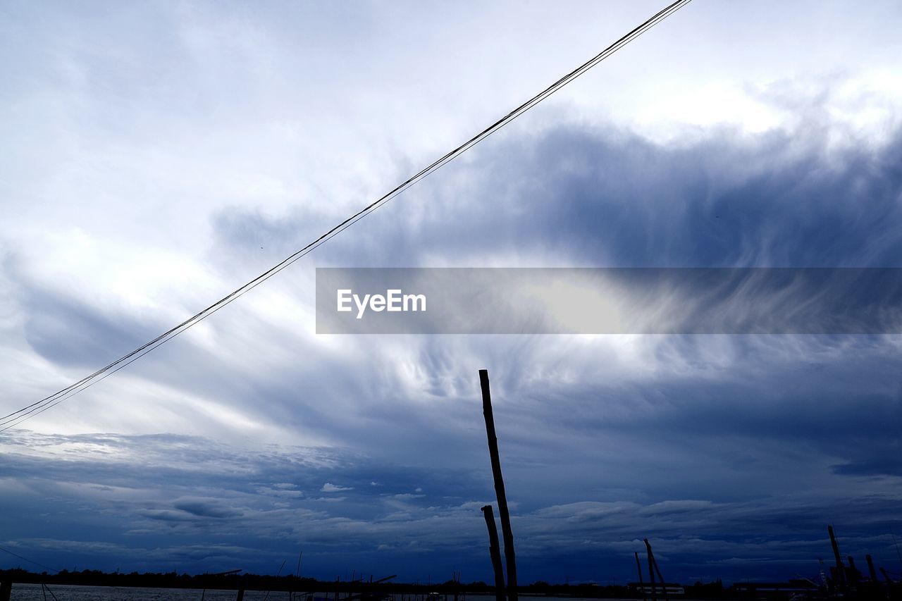 LOW ANGLE VIEW OF SILHOUETTE CABLE AGAINST SKY